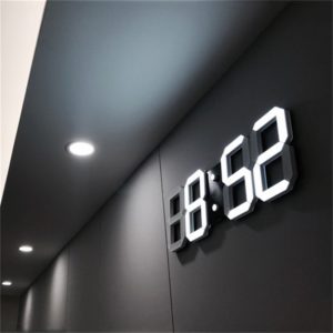 A wall mounted clock with the numbers 8 : 5 2.