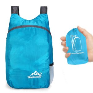 A blue backpack and water bottle in one hand.